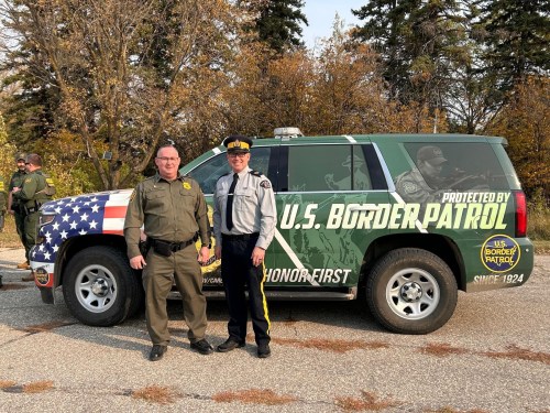 Submitted by the RCMP D Division
Chief patrol agent Scott Garrett (left) with RCMP Sgt. Lance Goldau stand in front of a U.S. Border Services Patrol SUV. The two police organizations met at the Pembina and Emerson to share knowledge with one another. Both are concerned with illegal border crossings and urge those thinking of crossing the border to do so legally.