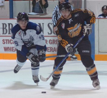 Legacy Brandon Sun BRUCE BUMSTEAD/BRANDON SUN   Swift Current Broncos' Zack Smith, #15, gets his stick up under Wheat Kings' Brandon Lockerby's stick during a battle in the neutral zone during Friday's exhibition game at the Keystone Centre.