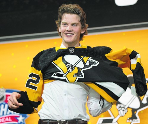 Pittsburgh Penguins  21st pick Owen Pickering puts on his jersey during the first round of the 2022 NHL Draft   Thursday, July 7, 2022 in Montreal. THE CANADIAN PRESS/Ryan Remiorz