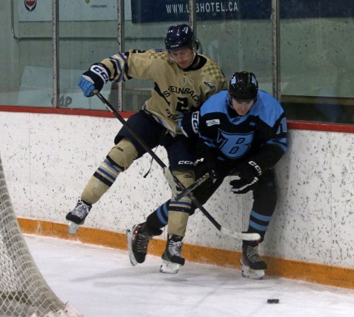 Zhenya Miles goes for a hit on a Winnipeg Blues player during a game Dec. 13. (Cassidy Dankochik The Carillon)