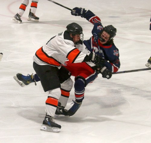 Ste Anne's Jace Gratton lays a hit on a Mitchell player in Hanover-Tache Junior Hockey League action earlier this season. The HTJHL Aces may be the busiest hockey team in Manitoba over the holidays, with games Dec. 28 and 29 at the Maurice Chaput Arena.