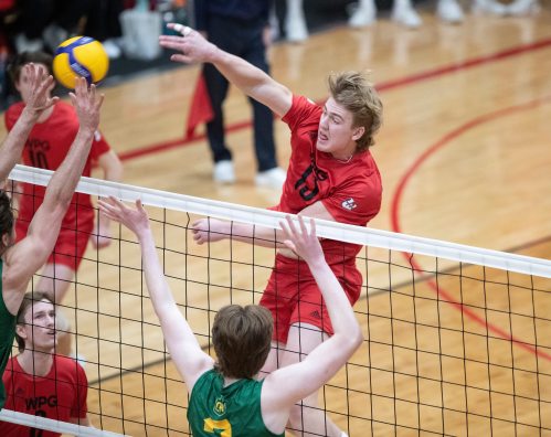 BROOK JONES/FREE PRESS
The University of Winnipeg Wesmen play host to the Canada West Men's Volleyball Championship gold medal game for the first time in their program history at the Duckworth Centre in Winnipeg, Man., Saturday, March 8, 2025. The No. 1 seeded U of W Wesmen won the CanWest championship title against the No. 2 seeded Univesity of Alberta Golden Bears 3-0 (25-20, 25-20, 25-21). Pictured: U of W Wesmen middle Easton Dick spikes the ball as U of A Golden Bears outside Isaac Heslinga (left) and middle Owen Harris (right) go up for the block during first set action.